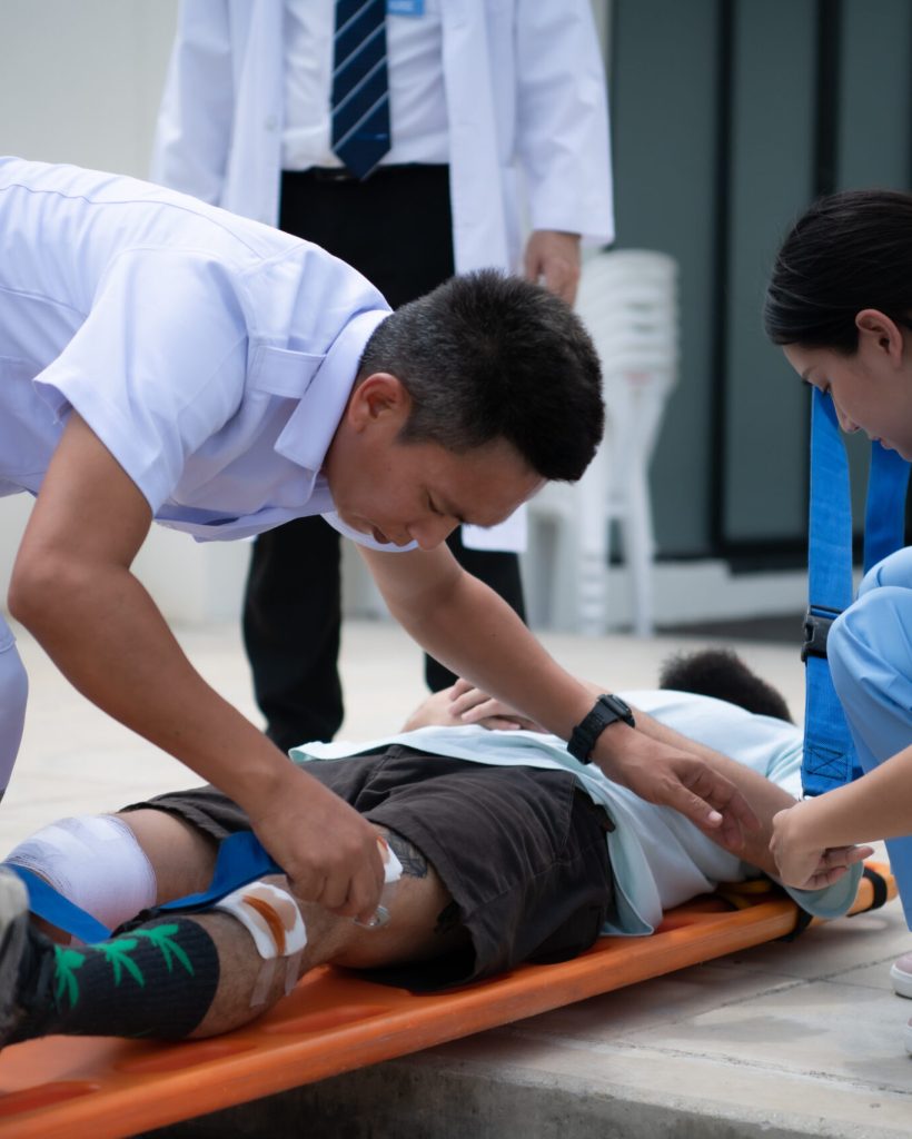 First aid assistance of the ambulance medical team with CPR method and hand-squeezed breathing apparatus