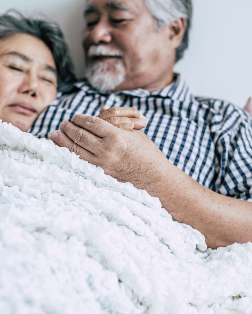 Senior couple lying in bed together
